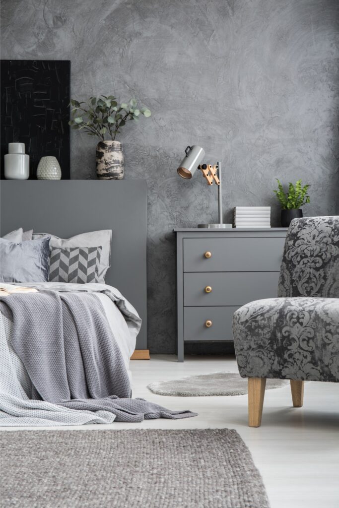 stylish-standing-lamp-next-to-a-bed-in-a-monochrom